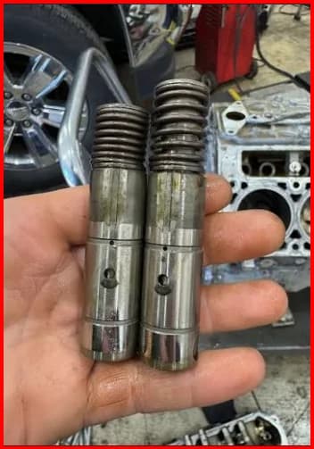 Collapsed GM 5.3 AFM lifter removed from a Silverado — the roller failure that wipes the cam lobe